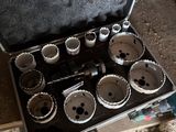 a man holding a tool case with a bunch of holes in it