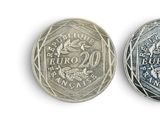 an old and new one euro coin on a white background
