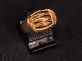 a close up of a gold ring on a black surface