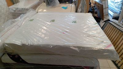 a lot of mattresses sitting on top of each other in a room