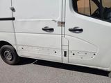 a small white van parked on the side of the road