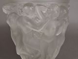 a glass vase with a design on it on a table