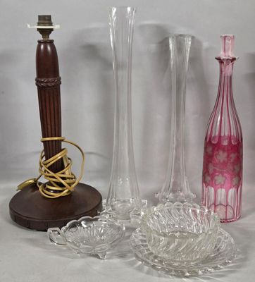 three vases and a candle holder on a table