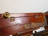 a wooden box with a metal latch on top of it