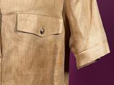 a beige shirt with a buttoned collar and a buttoned back