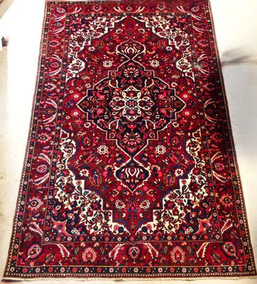 an image of a red rug on a white floor