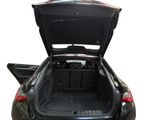 the back of a black car with its trunk open and the back door open