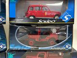 three boxed boxes of red toy cars sitting on top of each other