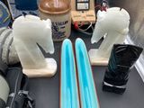 three snowboards and a pair of skis on a table