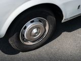 a close up of a car with a flat tire on the street