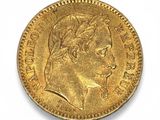 a close up of a gold coin on a white surface