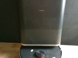 an image of a black and gray air purifier sitting on top of a wooden table
