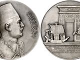 an image of a silver medal with a picture of a man on it