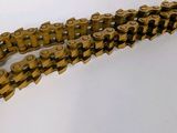 a gold chain that has been placed on a white surface