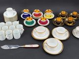 many different types of cups and saucers on the table