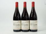 three bottles of red wine sitting next to each other on a table