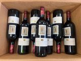 six bottles of red wine in a cardboard box on a table