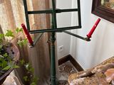 a music stand in the corner of a room with a painting on the wall