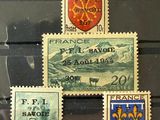 four stamps on display in a glass case with a coat of arms on them