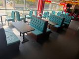 tables and chairs in a restaurant with a view of the street