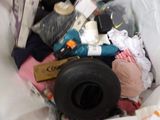 a trash can filled with clothes and other items