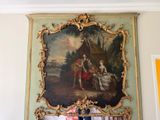 a painting hanging on the wall above a fireplace
