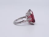 a pink tourmaline and diamond ring on a white background