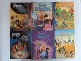 plusieurs livres pour enfants sont alignés sur une surface blanche