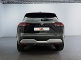 the rear end of a black nissan qxv parked in a garage