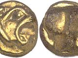 a close up of two gold coins on a white surface