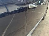 a close up of a car door handle with a sticker on it
