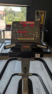 a view of a tread machine in a gym room