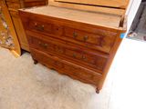 a dresser with a mirror on top of it in a room