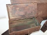 an old metal box sitting on a white surface