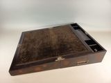 an old wooden box with two compartments on a white surface