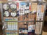 a metal cart with many items in it in a warehouse