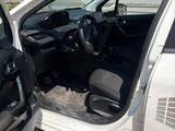 a white car with the door open and the driver ' s seat down