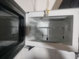 a white microwave with a door open on a counter