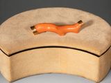 wooden box with an orange handle sitting on top of a gray surface