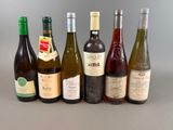 several bottles of wine are lined up in a row on a table
