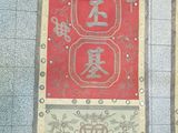 two red banners with chinese writing on them on a tile floor
