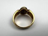 a close up of a gold ring with a diamond on it