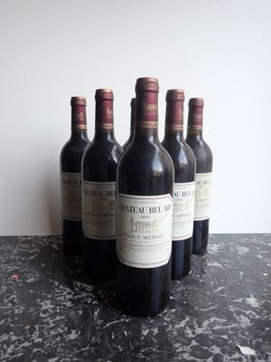 several bottles of wine are lined up on a table