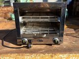 a toaster oven sitting on top of a piece of wood