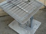 a metal table that is sitting on the ground