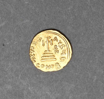 an image of a gold coin sitting on top of a table