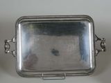 an antique silver tray with handles and handles on a white surface