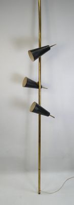 a tall brass and black floor lamp with three black lamps on it
