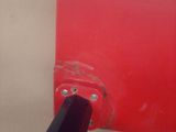 a black pipe sticking out of a red piece of paper