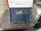 a laptop sitting on top of a table next to a box